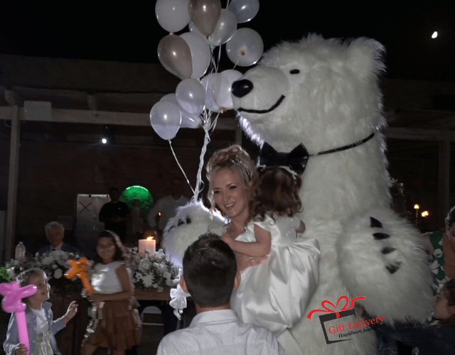 The White Polar Bear came to the wedding to deliver the gift to the bride and groom. Gift Delivery. Wedding gift. Surprise from the Political bear. White Polar Bear at the wedding.